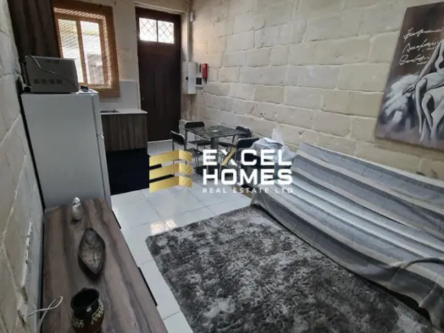 a room with a wall of bricks and a wall of bricks