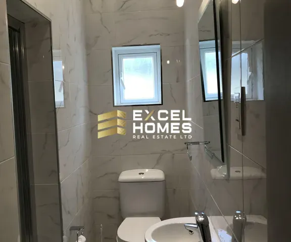 a bathroom with a toilet and a window