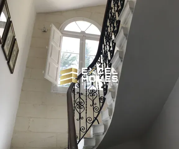 a staircase leading to a balcony with a view of the stairs