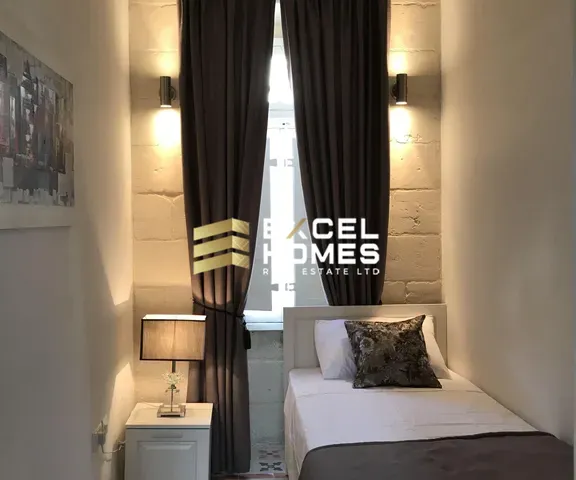 a hotel room with a large window and a bed