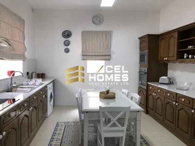 a kitchen with a stove, sink, and refrigerator