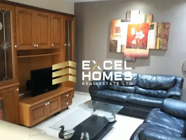 a living room with a couch, chair, and a television