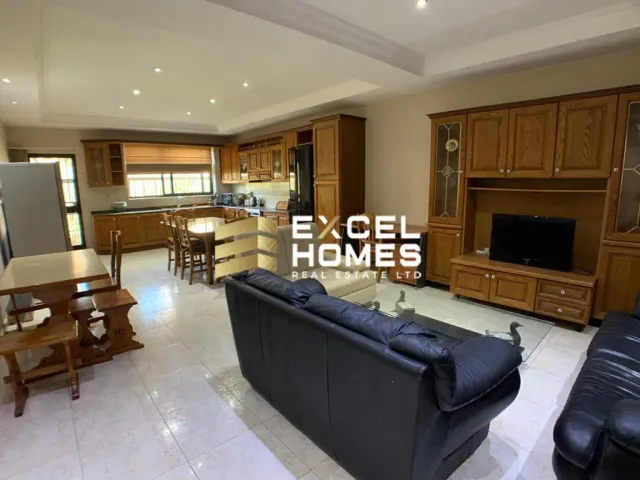 a living room with a couch, coffee table and a television