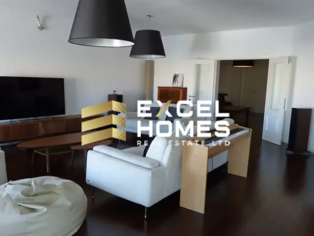 a living room with a couch, chair, and a lamp 