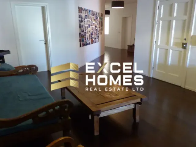 a living room with a couch, chair, and a table 