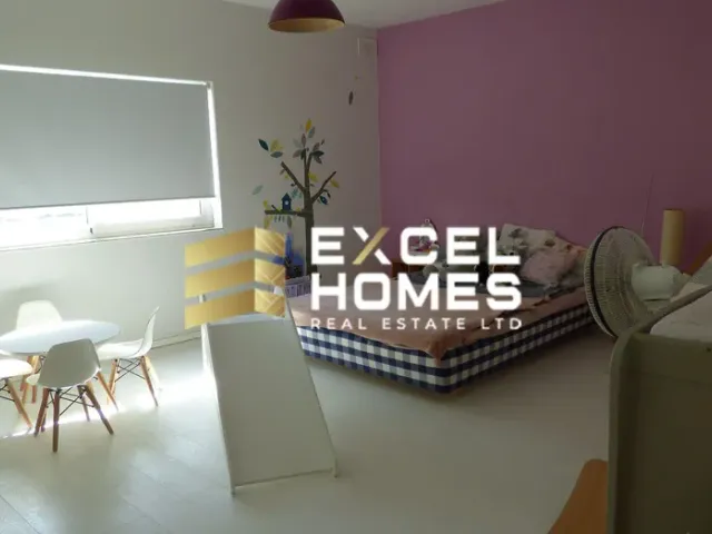 a living room with a table and a chair 