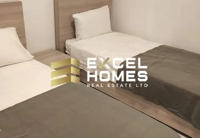 a bed with a white bedspread and pillows