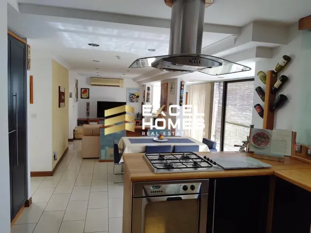 a kitchen with a stove, sink, and refrigerator 