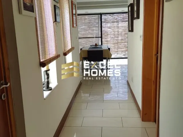 a small room with a window and a table 