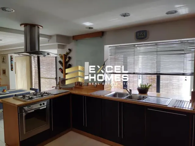 a kitchen with a sink, stove, and a window 