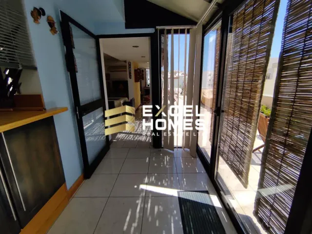 a hallway with a door open and a window 