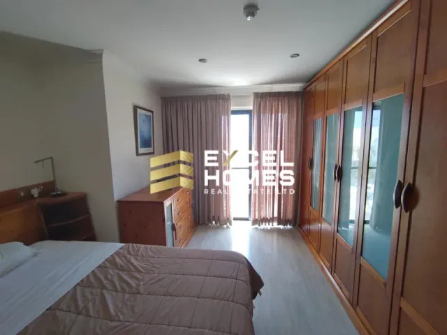 a woman is standing in a bedroom with a bed 