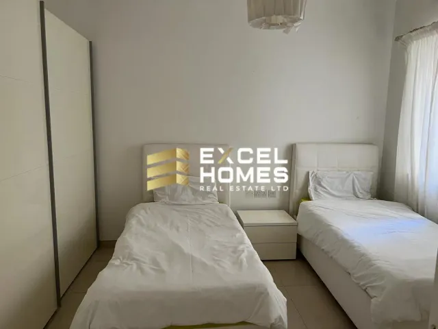 a bedroom with a bed, a lamp and a window 