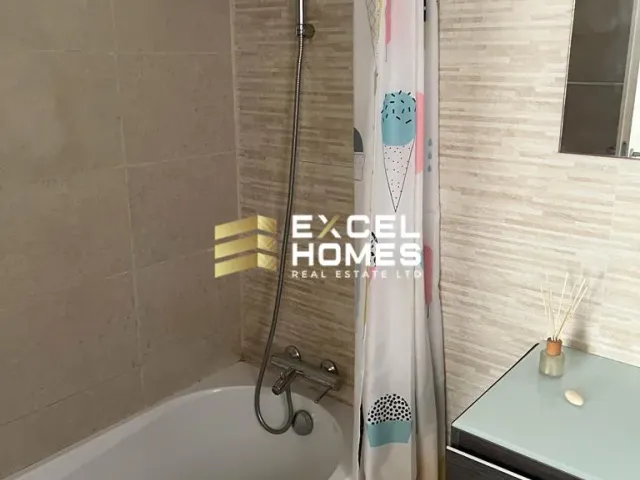a bathroom with a shower, sink, and toilet 