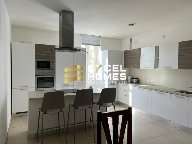a kitchen with a refrigerator, stove, sink and a microwave 