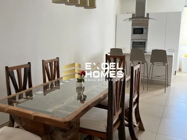 a dining room table with chairs and a table cloth 