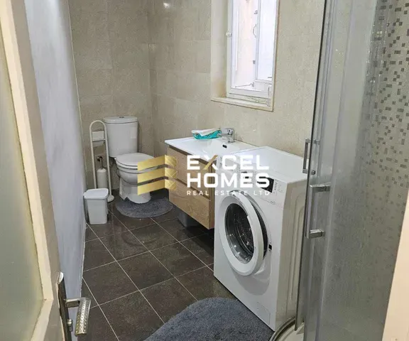 a white toilet sitting next to a white sink 