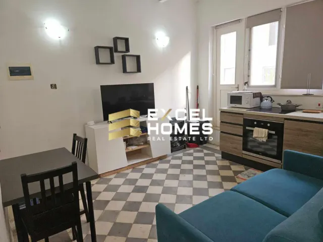 a living room with a couch, coffee table and a tv 