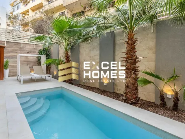 a swimming pool with a large swimming pool and a large blue umbrella 