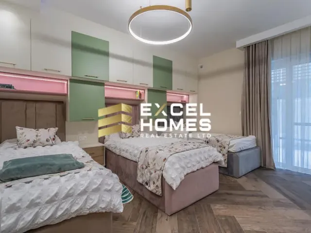 a bedroom with a bed, a desk, and a lamp 