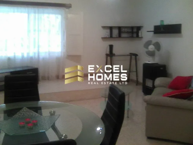 a living room with a couch, chair, and a television