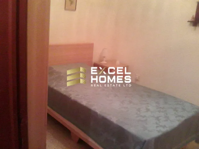 a bed with a blue and white bedspread and a blue and white bedspread