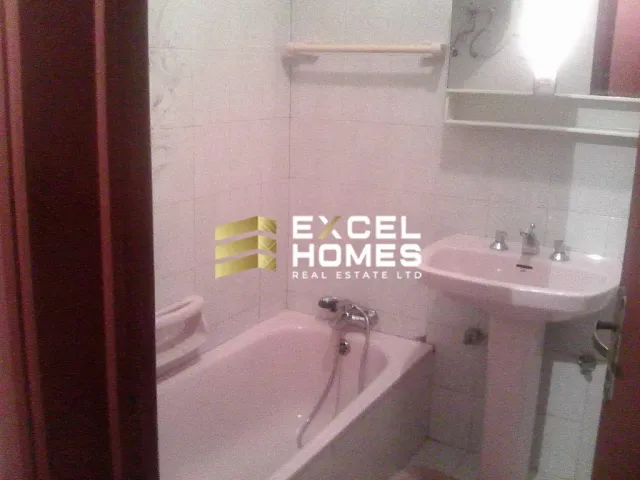 a bathroom with a sink, mirror, and bathtub
