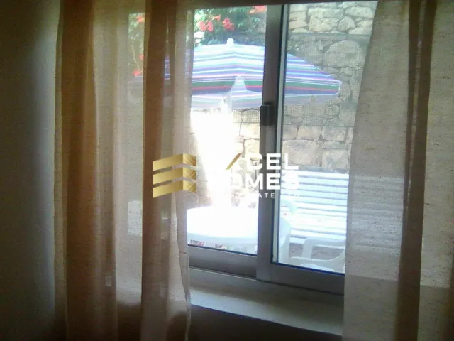 a window with a curtain and a window blind