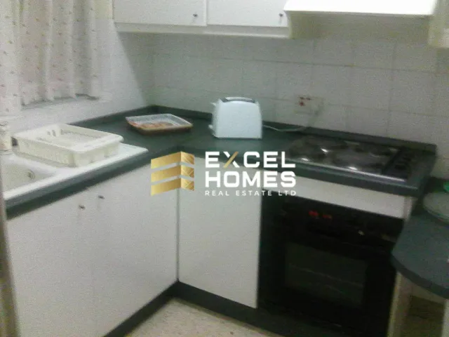 a kitchen with a stove, microwave, and a sink