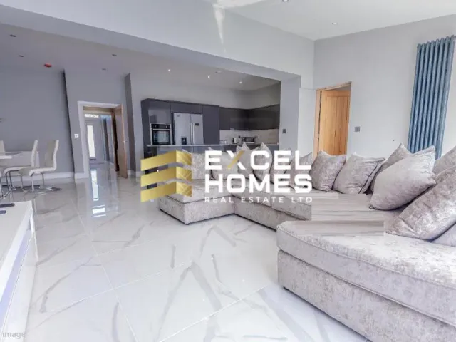 a living room with a couch, coffee table, and a television 