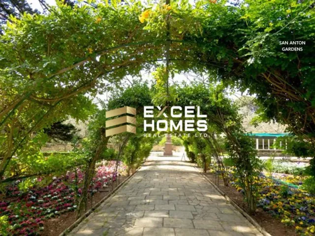 a wooden walkway with a flower garden 