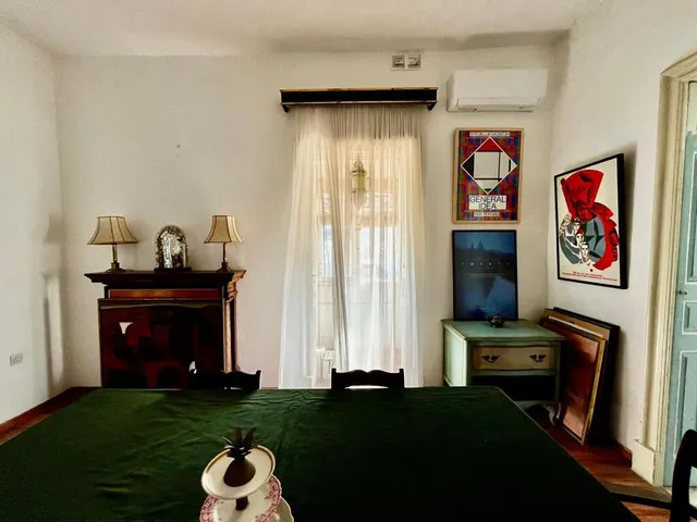 a bedroom with a bed, a dresser, and a window 
