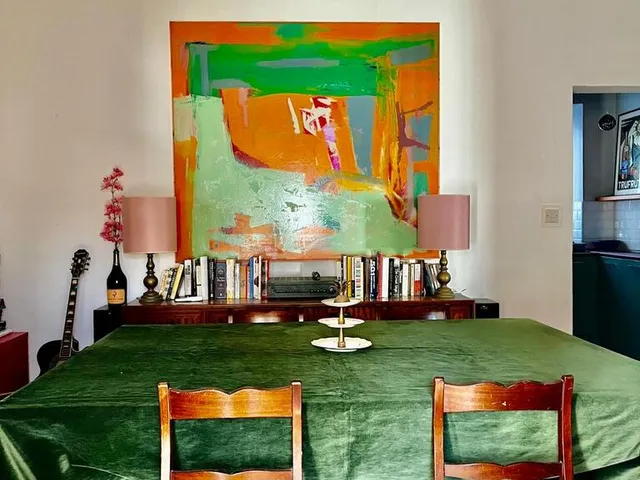 a table with a bed and a table cloth 