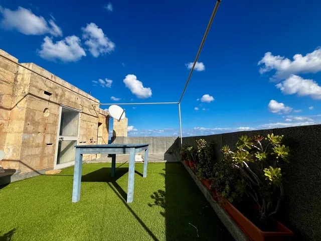 a bench sitting on top of a lush green field 