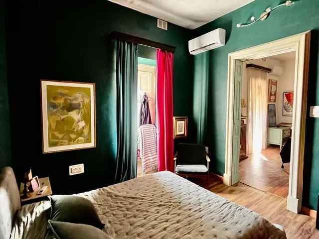 a bedroom with a large bed and a large window 