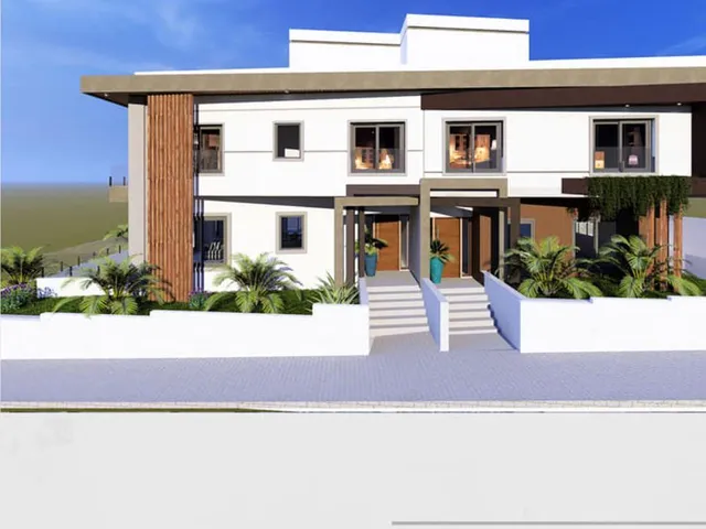 a white house with a blue roof and a white building