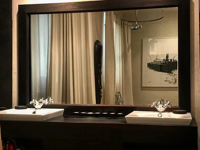 a bathroom with a mirror and a sink
