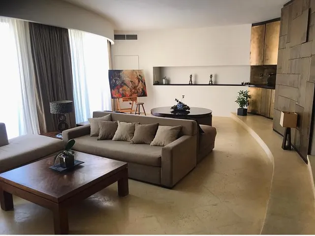 a living room with a couch, table, and chairs