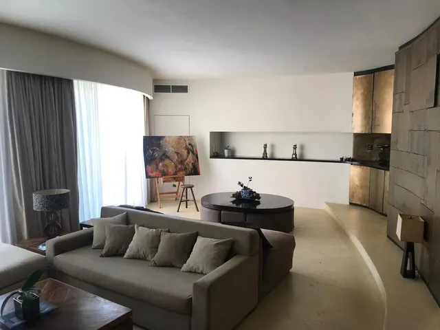 a living room with a couch, coffee table and a tv