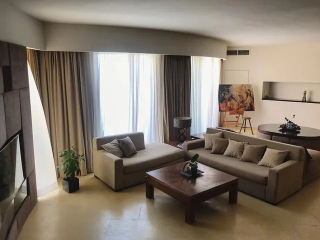 a living room with a couch, chair, and table