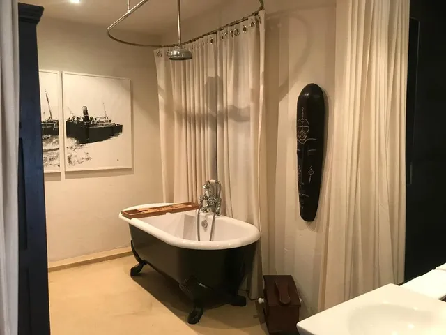 a bath tub sitting next to a shower