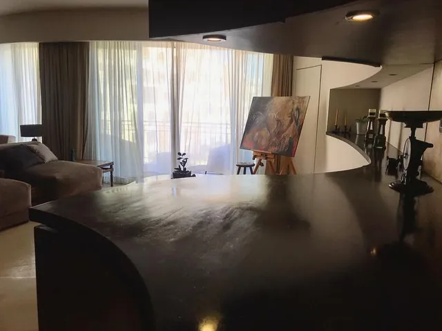 a room with a bed, table, and a window