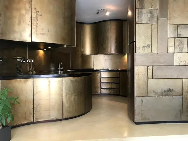 a kitchen with stainless steel appliances and a stainless steel refrigerator