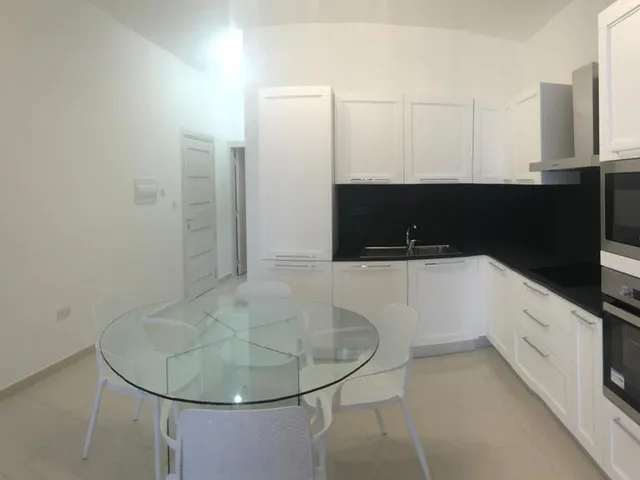 a kitchen with a table and a microwave