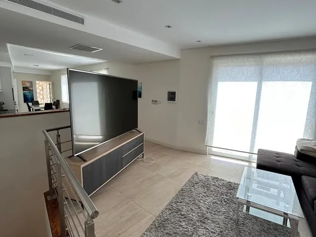 a living room with a tv and a window