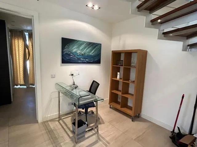 a room with a wooden table and a wooden chair