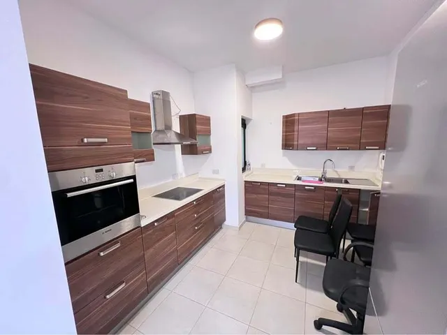 a kitchen with a stove, microwave, sink and refrigerator