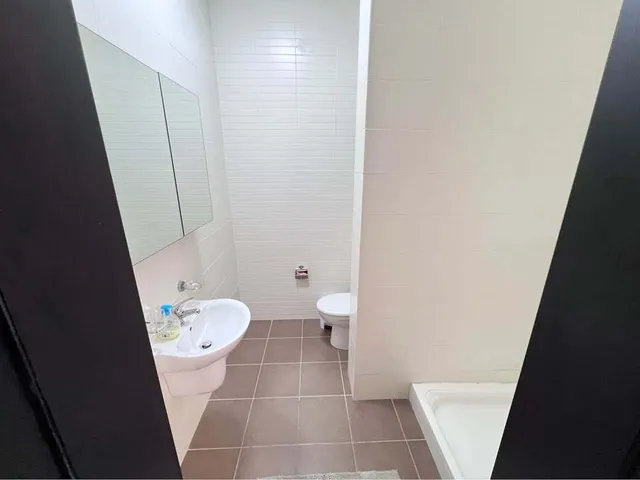 a bathroom with a toilet, sink, and shower
