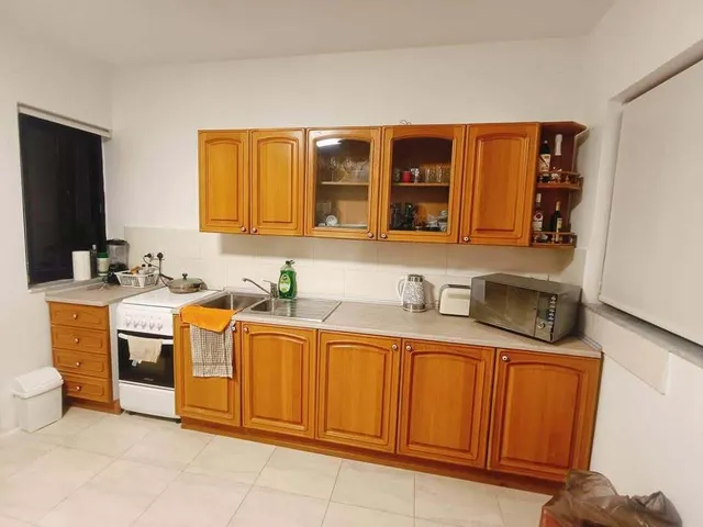 a kitchen with a sink, stove, and cabinets 