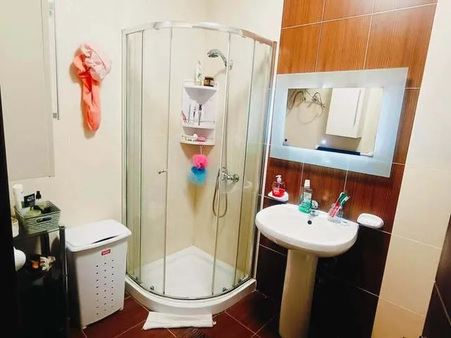 a bathroom with a sink, toilet, and shower 
